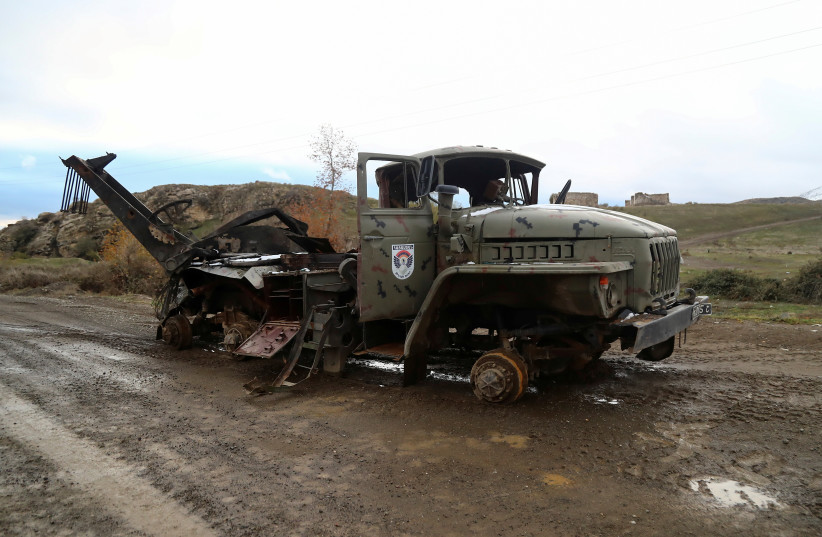  A view shows a damaged truck belonging to ethnic Armenian forces in an area that came under the control of Azerbaijan's troops following a military conflict over Nagorno-Karabakh, in Jabrayil District, December 7, 2020. (photo credit: AZIZ KARIMOV/REUTERS)