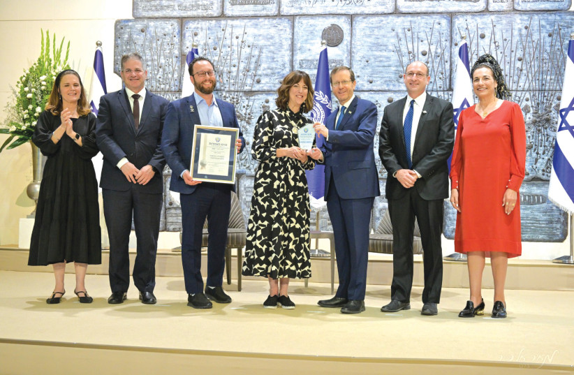  FROM LEFT: Deputy Finance Minister Michal Waldiger, Education Minister Yoav Kisch, MOMentum CEO Ben Pery, the writer, President Isaac Herzog, and Ophir and Bat-Galim Shaer pose at the Jerusalem Unity Prize ceremony at the President’s Residence last week. (photo credit: MEIR ELIPUR)