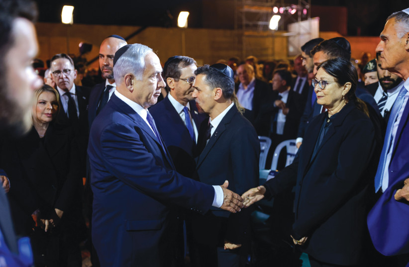  PRIME MINISTER Benjamin Netanyahu shakes hands with Supreme Court President Esther Hayut on Holocaust Remembrance Day at Yad Vashem. (photo credit: ERIK MARMOR/FLASH90)