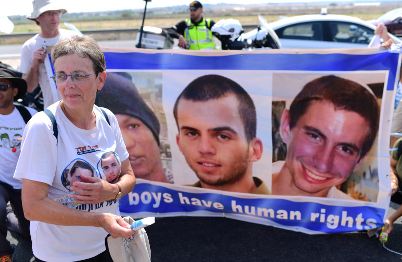  Friends, family and activists hold a protest march calling for the return of killed Israeli soldiers Oron Shaul, Hadar Goldin and captive Israeli citizen Avera Mengistu near Ashdod, August 5, 2022 (photo credit: TOMER NEUBERG/FLASH90)