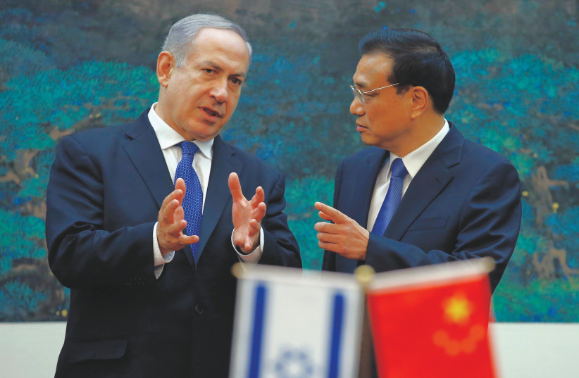  PRIME MINISTER Benjamin Netanyahu talks to China’s then-premier Li Keqiang during a signing ceremony at the Great Hall of the People in Beijing, in 2013.  (photo credit: REUTERS/KIM KYUNG-HOON)