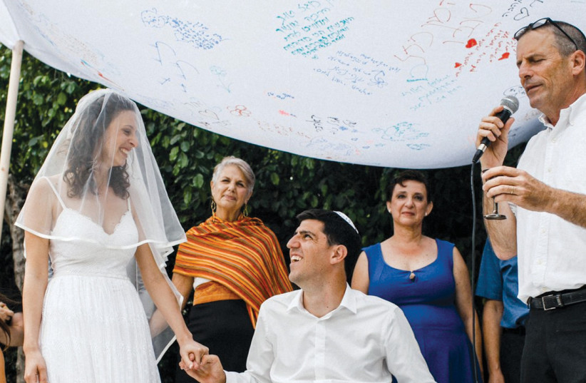  Rabbi Elisha Wolfin (right), marrying Ori and Yasmin. (photo credit: MICHAEL TUMARKIN)