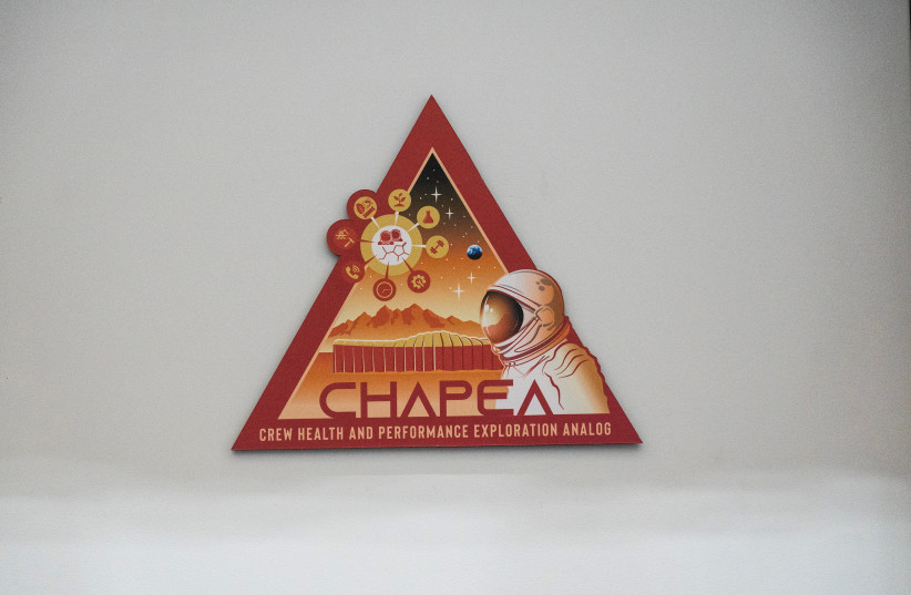  A CHAPEA logo, Crew Health and Performance Exploration Analog, is seen on the entrance door of the Mars Dune Alpha, NASA's simulated Mars habitat, being used as preparations for sending humans to the Red Planet, at the agency's Johnson Space Center in Houston, Texas, U.S. April 11, 2023. (photo credit: REUTERS/Go Nakamura)