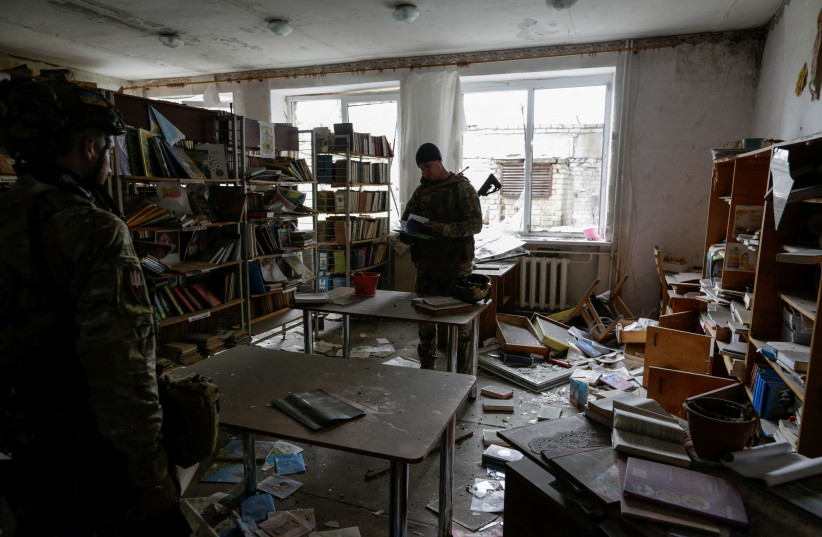  Ukrainian servicemen inspects a damaged school building in the village near a frontline in Donetsk region. (photo credit: REUTERS)
