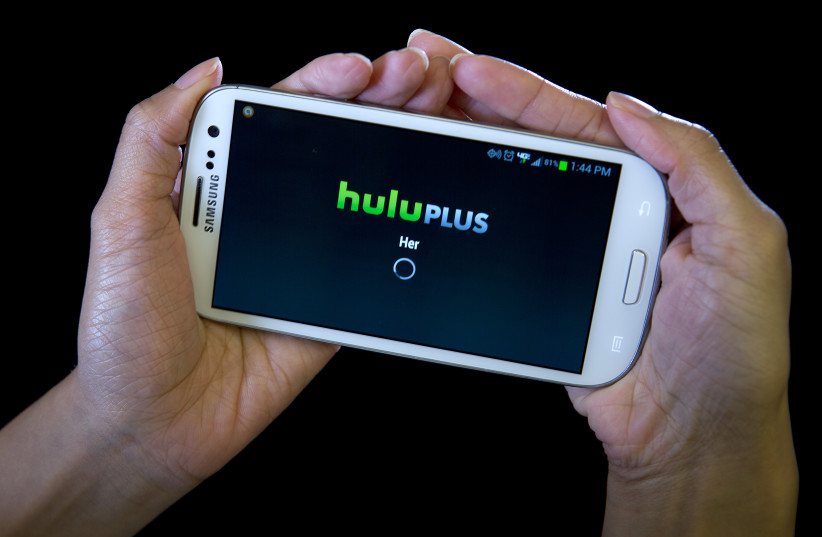 The HULU Plus app is played on a Samsung Galaxy phone in this photo-illustration in New York, December 23, 2013. Hulu has failed to persuade a federal judge to dismiss a lawsuit accusing the video streaming service of illegally sharing users' viewing history with Facebook Inc and business metrics co (photo credit: CARLO ALLEGRI/REUTERS)