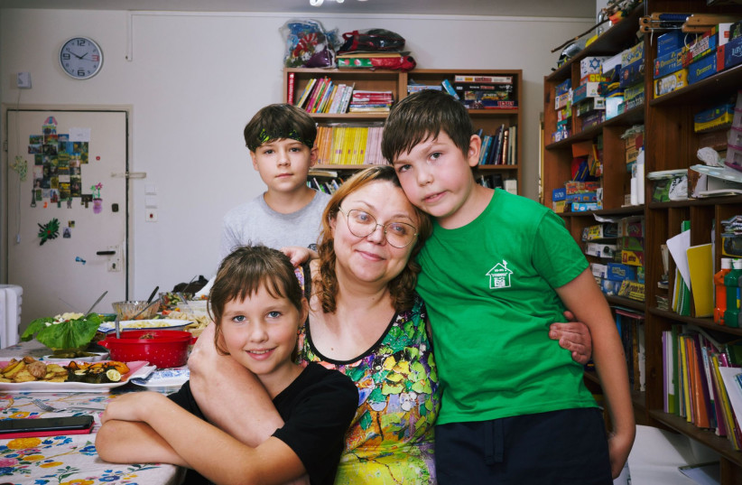  Volunteer Lena Dubrovin with children in her apartment, a shelter for numerous Russian and Ukrainian refugees since the start of the war, June 21, 2023.  (photo credit: DARIO SANCHEZ/THE MEDIA LINE)