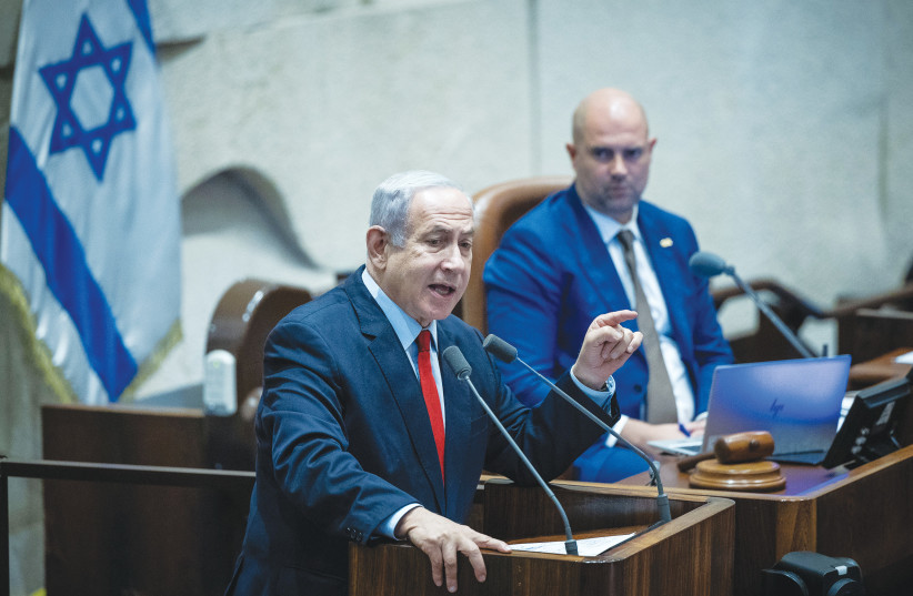  PRIME MINISTER Benjamin Netanyahu addresses the Knesset last week, as Knesset Speaker Amir Ohana looks on. (photo credit: YONATAN SINDEL/FLASH90)