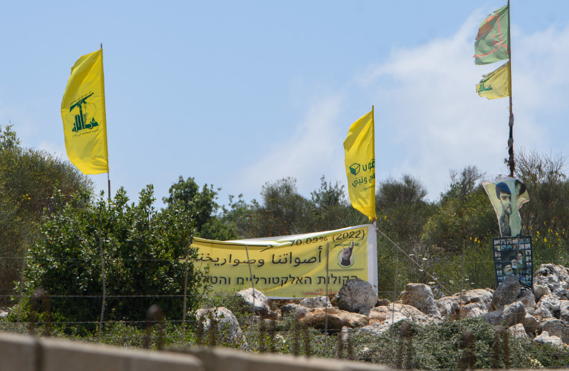 Hezbollah flags on the border between Israel and Lebanon, northern Israel, July 03, 2022. (photo credit: AYAL MARGOLIN/FLASH90)