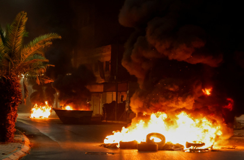 View of tyres set on fire on a street after a Palestinian was killed during an Israeli military operation, in Jenin, in the West Bank July 3, 2023. (photo credit: REUTERS/RANEEN SAWAFTA)