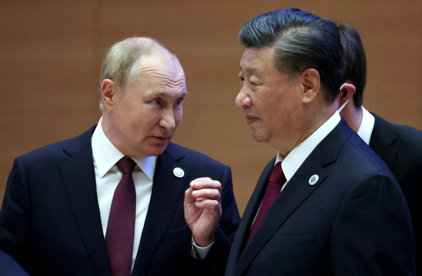  Russian President Vladimir Putin speaks with Chinese President Xi Jinping before an extended-format meeting of heads of the Shanghai Cooperation Organization summit (SCO) member states in Samarkand, Uzbekistan September 16, 2022. (photo credit: Sputnik/Sergey Bobylev/Pool via REUTERS)
