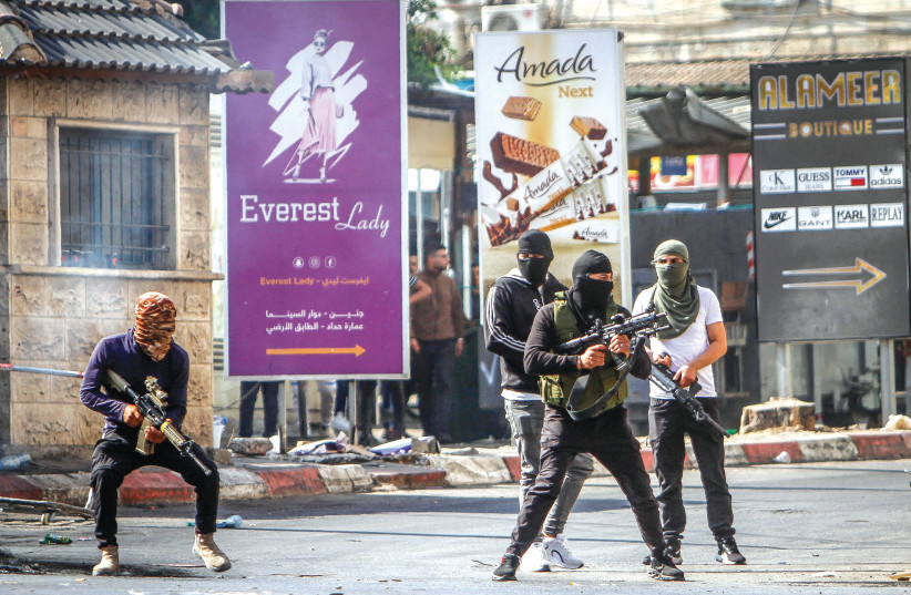  PALESTINIAN GUNMEN take to the streets of Jenin on Monday, after Israel began a military operation. (photo credit: NASSER ISHTAYEH/FLASH90)