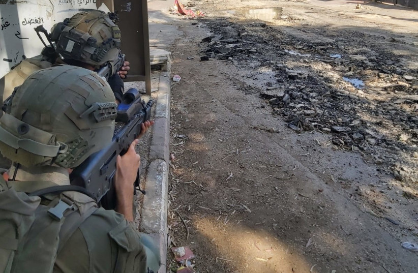  IDF soldiers take up a defensive position in the Jenin refugee camp on July 4, 2023 during a large-scale IDF operation in the area.  (photo credit: YONAH JEREMY BOB)