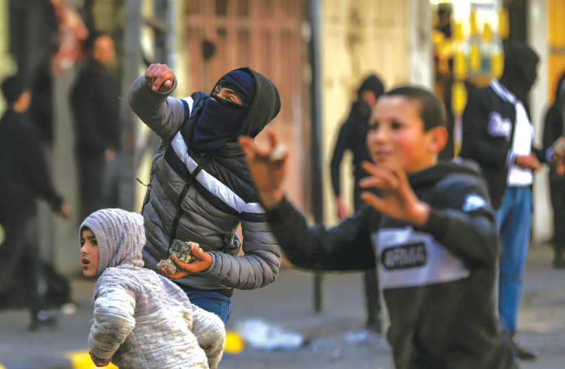  YOUNG PALESTINIANS clash with Israeli soldiers in Jenin, earlier this year. (photo credit: WISAM HASHLAMOUN/FLASH90)