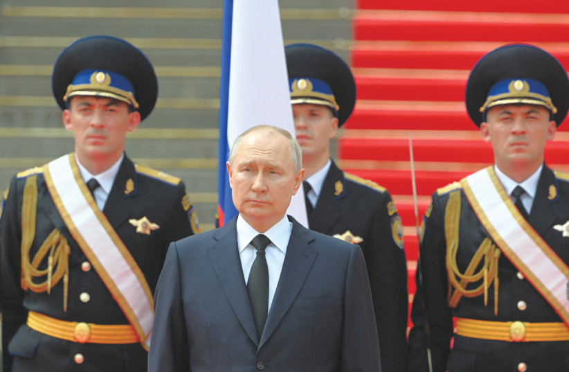  RUSSIAN PRESIDENT Vladimir Putin stands in front of members of Russian military units, the National Guard and security services, praising them for upholding orders during a mutiny by the Wagner Group, last month. (photo credit: SPUTNIK/REUTERS)