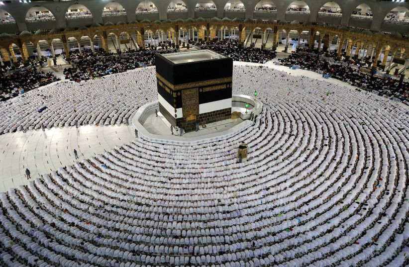 THE HAJJ: Muslim worshipers pray at the Grand Mosque in Saudi Arabia’s holy city of Mecca last July. (photo credit: AFP VIA GETTY IMAGES)