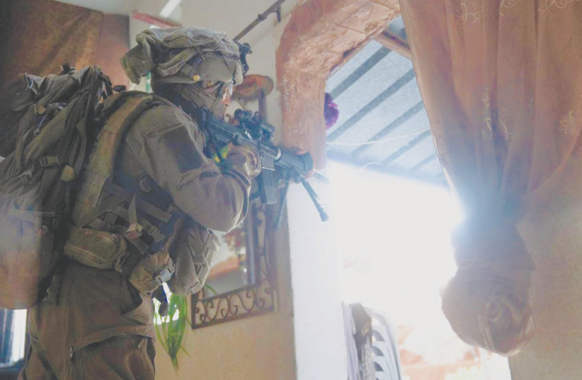  AN IDF soldier conducts door-to-door searches this week during the Jenin operation. (photo credit: IDF SPOKESMAN’S UNIT)