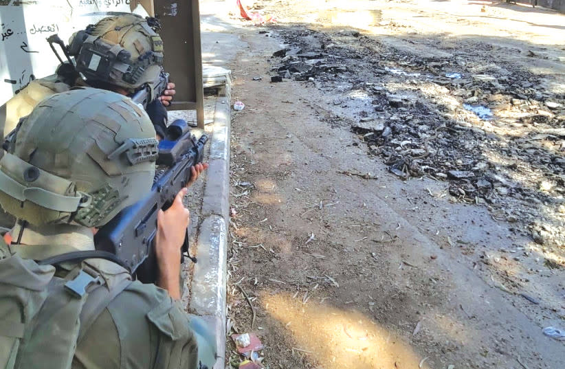  IDF SOLDIERS take up a defensive position in the Jenin refugee camp on Tuesday during this week’s large-scale IDF operation in the area. (photo credit: YONAH JEREMY BOB)