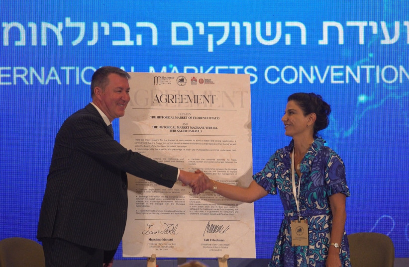  (L-R) Massimo Manetti and Tali Friedman sign the Matching Markets Deal between Florence's historic market and Machane Yehuda, July 3, 2023 in Jerusalem. (photo credit: DARIO SANCHEZ/THE MEDIA LINE)