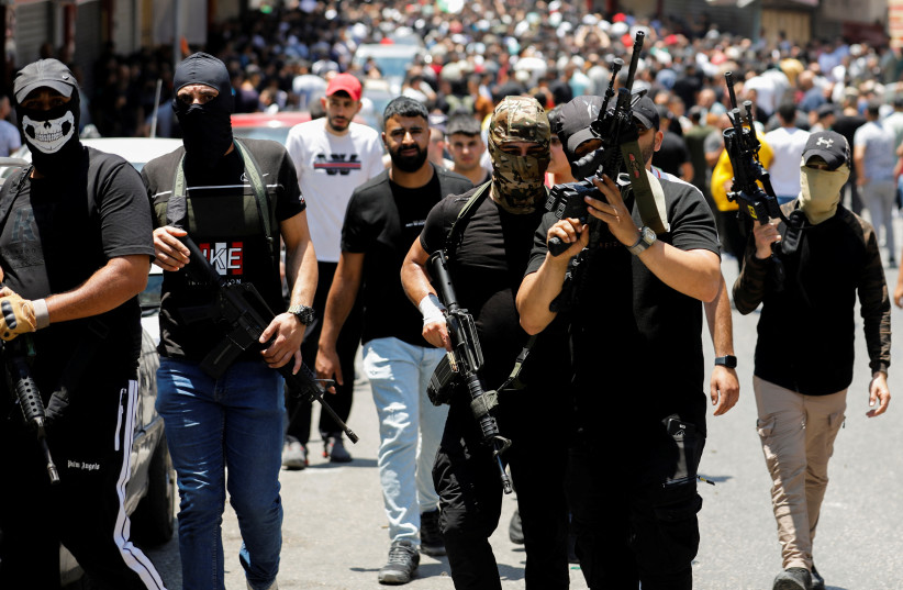 Gunmen attend a funeral of two Palestinians, who were killed during an Israeli raid, in Nablus in the West Bank July 7,2023. (photo credit: RANEEN SAWAFTA/REUTERS)