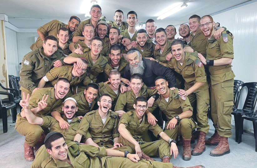  THE RABBI is surrounded by soldiers at the Latrun IDF Educational Center, during a get-together earlier this year.  (photo credit: Courtesy, Rabbi Sholom Myers)