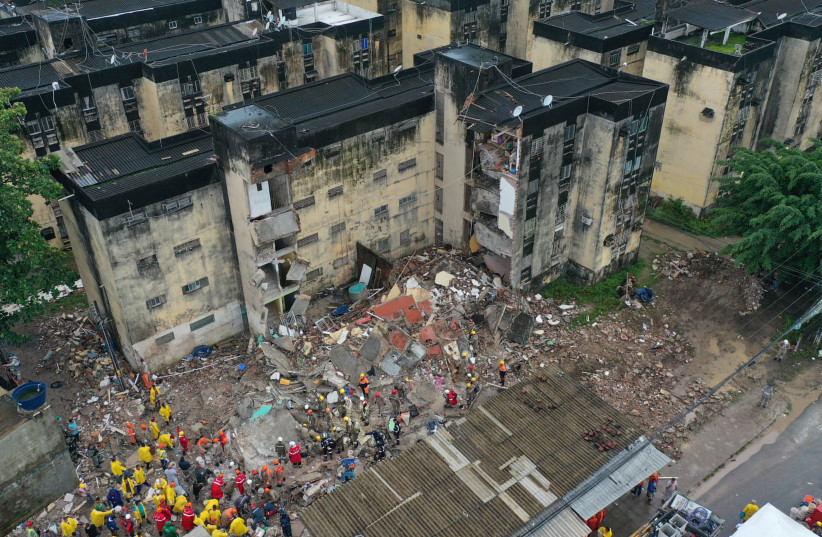  Rescue workers look for victims among debris of a building collapse in Recife, Pernambuco state, Brazil July 7, 2023. (photo credit: REUTERS/ANDERSON STEVENS)