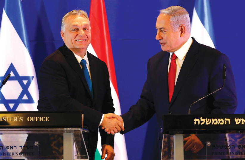  PRIME MINISTER Benjamin Netanyahu and Hungarian counterpart Viktor Orban shake hands after meeting in Jerusalem, in 2019. (photo credit: Ariel Schalit/Reuters)