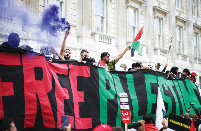  PROTESTERS HOLD a ‘Free Palestine’ banner near Downing Street in London in 2021. How many times have we heard: ‘I am not an antisemite, I am an anti-Zionist?’ (photo credit: HENRY NICHOLLS/REUTERS)