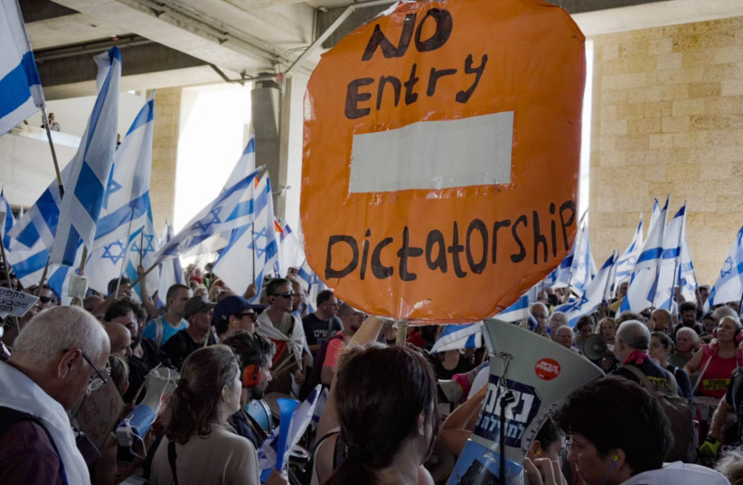  "No entry dictatorship" sign at Ben Gurion airport during the protests on July 11, 2023. (photo credit: CHEN LEOPOLD)