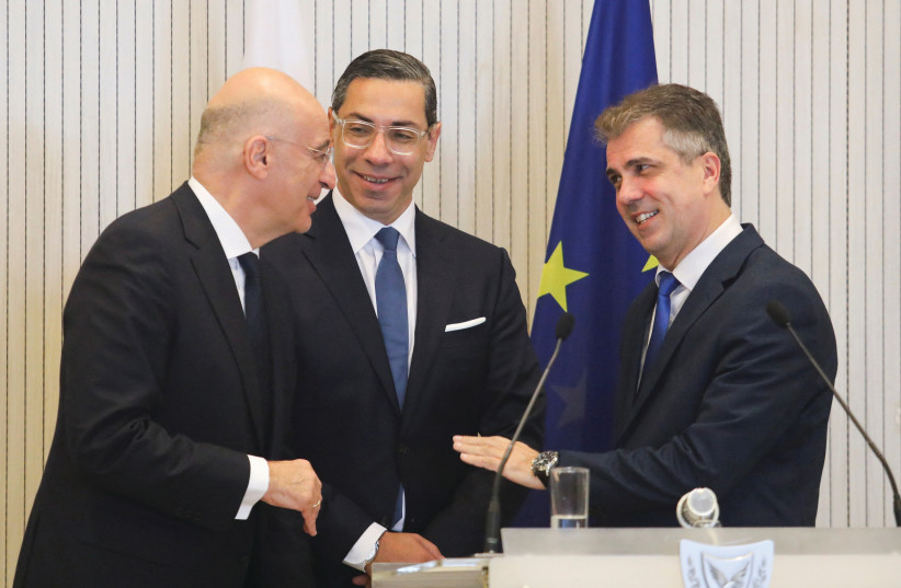  FOREIGN MINISTER Eli Cohen chats with his Cypriot and Greek counterparts after a conference in Nicosia, earlier this year.  (photo credit: YIANNIS KOURTOGLOU/REUTERS)