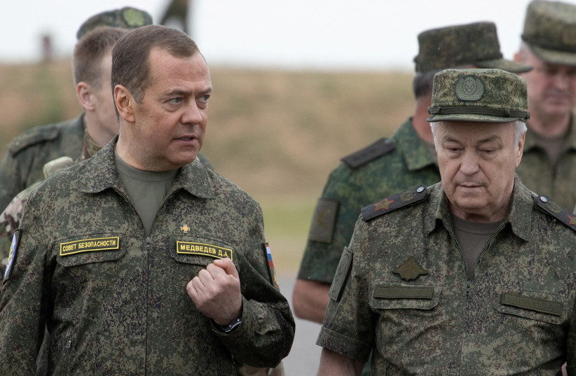  Russia's Deputy head of the Security Council Dmitry Medvedev, accompanied by Deputy Defence Minister Nikolay Pankov, visits the Prudboi military training ground in Volgograd region, Russia June 1, 2023.  (photo credit: SPUTNIK/YEKATERINA SHTUKINA/POOL VIA REUTERS)