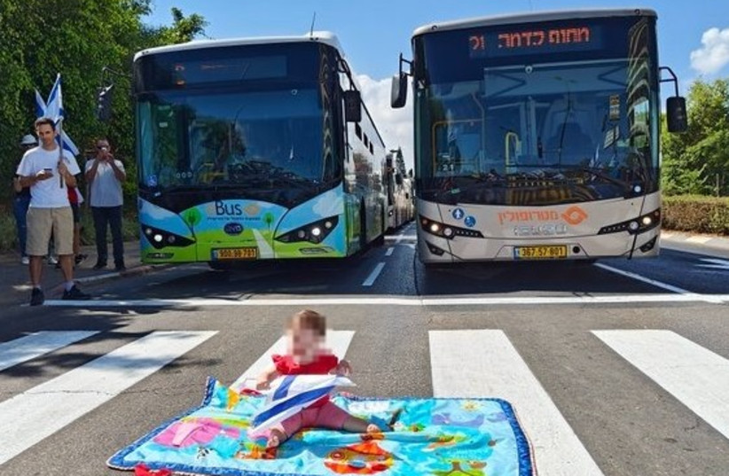  Baby in the middle of the road on 'Day of Resistance'. (photo credit: AMI DROR)