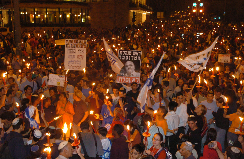  Right-wing protesters carry signs and protest in the streets of Jerusalem, against Prime Minister Ariel Sharon and the disengagement plan on September 13 2004 (photo credit: FLASH90)