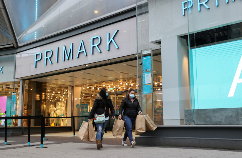  Customers walks with shopping bags, as retail store Primark in Birmingham, UK. (photo credit: REUTERS/CARL RECINE)