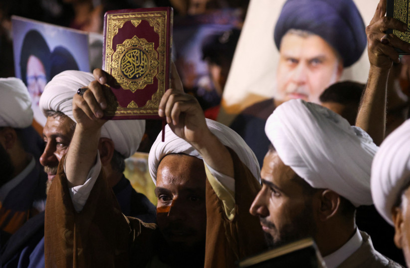  Supporters of Iraqi Shi'ite cleric Moqtada al-Sadr take part in a protest against a man who tore up and burned a copy of the Koran outside a mosque in the Swedish capital Stockholm, in Sadr city district of Baghdad, Iraq, July 12, 2023.  (photo credit: REUTERS/AHMED SAAD)