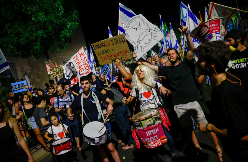  Anti-judicial overhaul demonstrators protest against the Israeli government's judicial overhaul, near Prime Minister Benjamin Netanyahu's residence in Jerusalem, on July 13, 2023. (photo credit: Chaim Goldberg/Flash90)