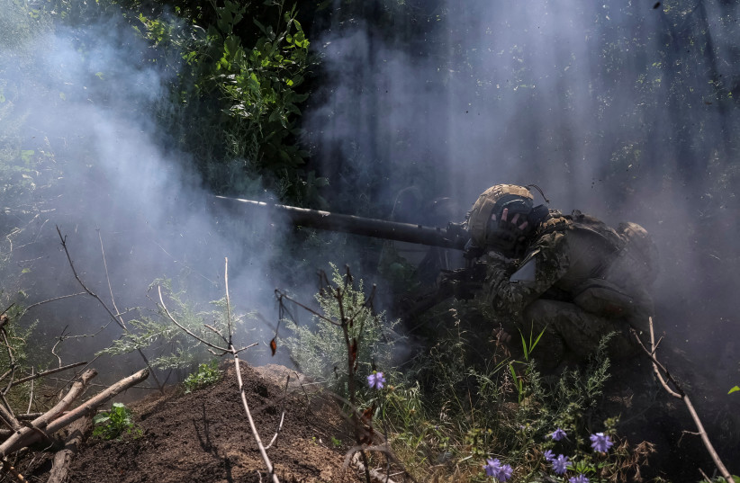  A Ukrainian serviceman, of the 10th separate mountain assault brigade of the Armed Forces of Ukraine, fires an anti-tank grenade launcher at his position at a front line, amid Russia's attack on Ukraine, near the city of Bakhmut in Donetsk region, Ukraine July 13, 2023.  (photo credit: REUTERS/Sofiia Gatilova/File Photo)