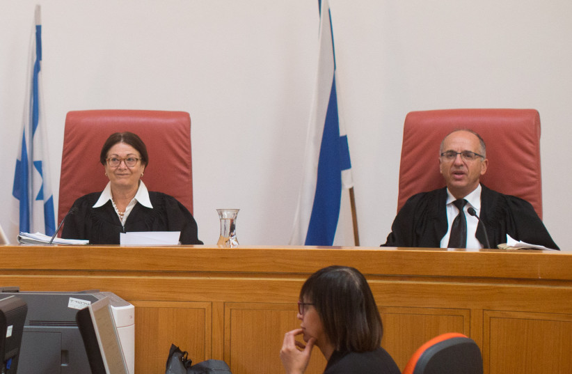 Supreme Court Justice Esther Hayut sits with Supreme Court Justice Noam Sohlberg during a court hearing. (photo credit: YONATAN SINDEL/FLASH90)