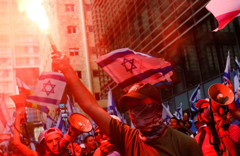  People demonstrate on the 'Day of National Resistance' in protest against Israeli Prime Minister Benjamin Netanyahu and his nationalist coalition government's judicial reform, in Tel Aviv, Israel July 18, 2023.  (photo credit: CORINNA KERN/REUTERS)