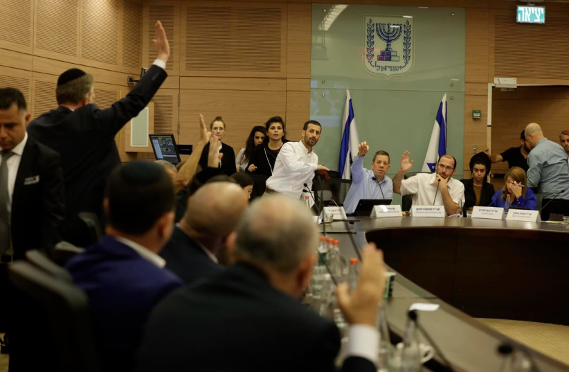  Israeli lawmakers are seen raising hands in a meeting of the Knesset's Constitution, Law, and Justice Committee, in Jerusalem, on July 19, 2023. (photo credit: MARC ISRAEL SELLEM/THE JERUSALEM POST)