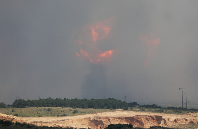  Smoke and flames rise from an explosion during a fire at a military training ground in the Kirovske district, Crimea, July 19, 2023. (photo credit: STRINGER/ REUTERS)