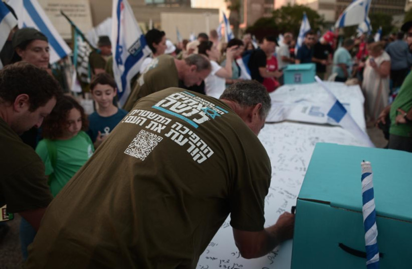  IDF reservists sign letters stating they will no longer show up for reserve service in light of the government's judicial reform plan. July 18, 2023 (photo credit: AVSHALOM SASSONI)