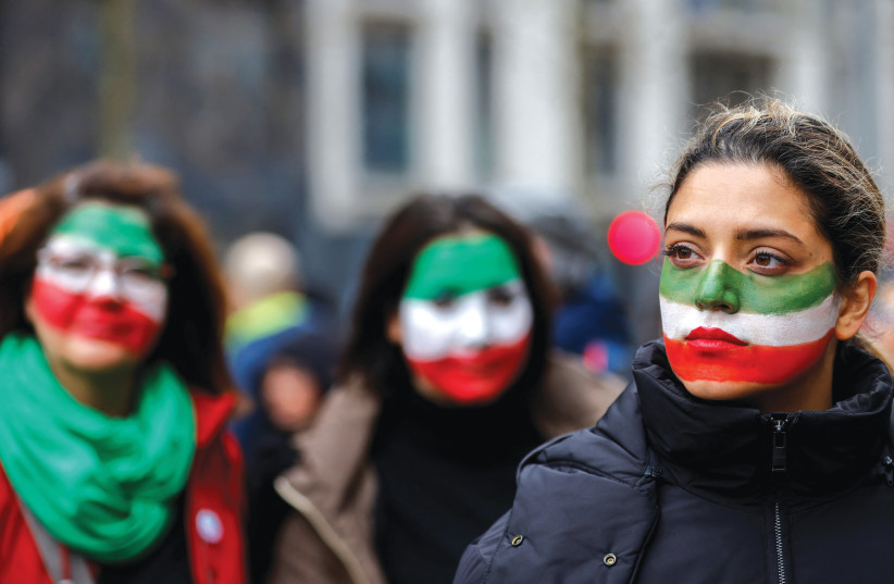  WOMEN, THEIR faces painted with the colors of Iran’s flag, take part in a protest to show solidarity with the Iranian people, in Brussels, earlier this year. (photo credit:  REUTERS/JOHANNA GERON)