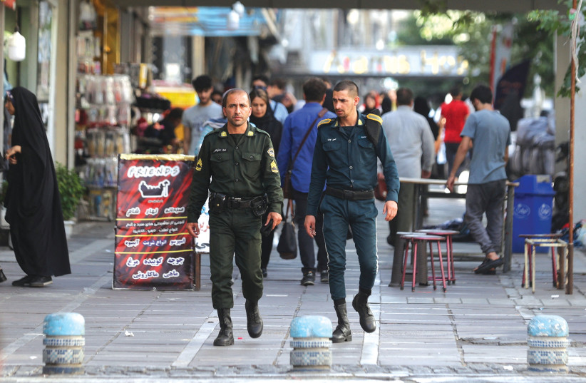  IRANIAN POLICE officers patrol a street amid the revival of the morality police in Tehran, this week.  (photo credit: WEST ASIA NEWS AGENCY/REUTERS)