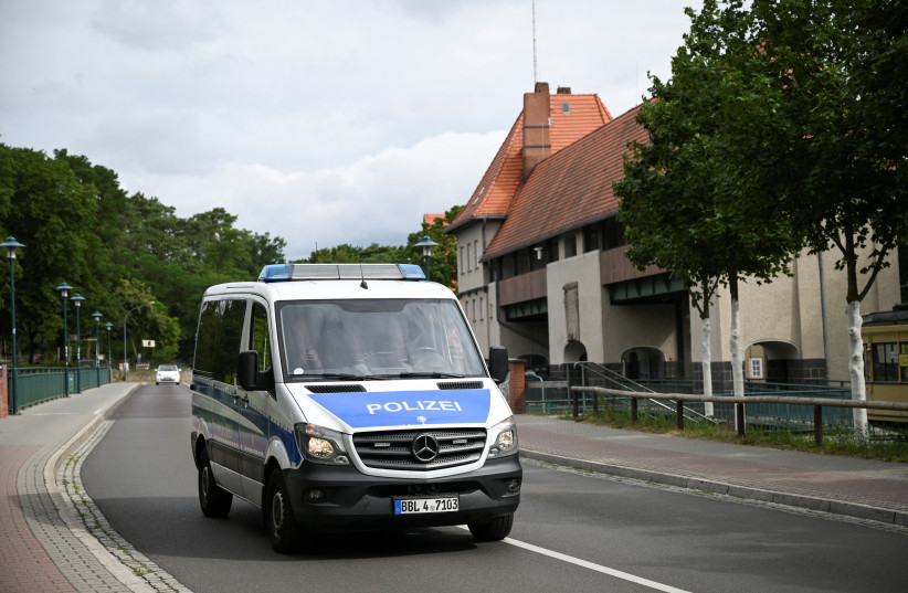 A Berlin police car crosses Stahnsdorfer Damm after police warned the public that a suspected lioness was on the loose in Kleinmachnow, near Berlin, Germany July 20, 2023. (photo credit: ANNEGRET HILSE / REUTERS)