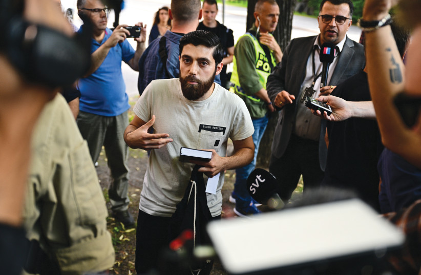  IN STOCKHOLM, Ahmad Alloush speaks to journalists on July 15 after being granted permission by Swedish police to burn a Torah and a Bible outside the Israeli embassy, in retaliation for a previous Quran burning there. Ahmad chose to instead denounce those who would burn sacred texts. (photo credit: Magnus Lejhall/Tt News Agency/AFP via Getty Images)