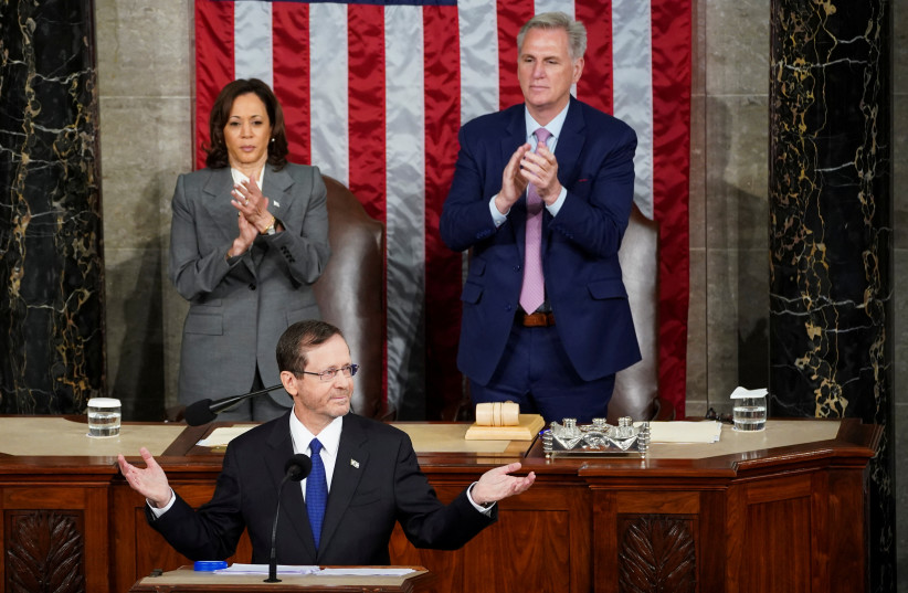  Israeli President Isaac Herzog gestures as U.S. Vice President Kamala Harris and U.S. House Speaker Kevin McCarthy (R-CA) applaud on the day of Herzog's address to a joint meeting of Congress inside the House Chamber of the U.S. Capitol in Washington, U.S., July 19, 2023. (photo credit: REUTERS/KEVIN LAMARQUE)