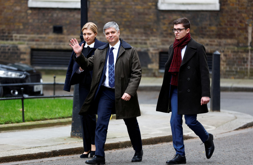 Vadym Prystaiko, who has been dismissed as Ukraine's ambassador to Britain, waves as he and his wife Inna Prystaiko walk outside Number 10 Downing Street on the first anniversary of Russia's full-scale invasion of Ukraine, in London, Britain, February 24, 2023 (photo credit: REUTERS/PETER NICHOLLS/FILE PHOTO)