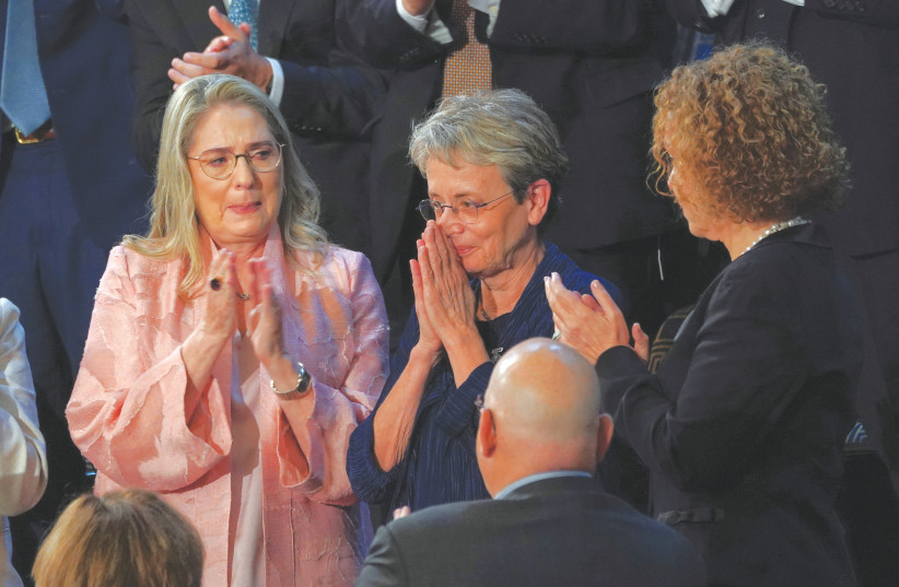  LEAH GOLDIN, mother of soldier Hadar Goldin, acknowledges President Isaac Herzog’s welcome at the president’s address to Congress last week, as Michal Herzog, the president’s wife (left), applauds (photo credit: KEVIN LAMARQUE/REUTERS)