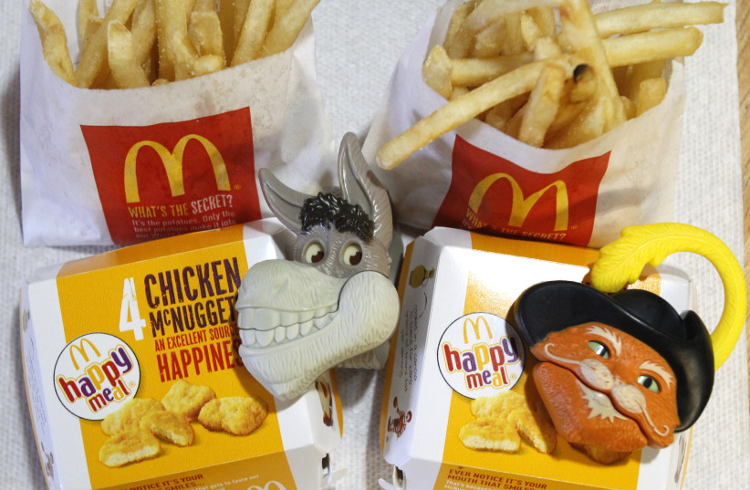 Two McDonald's Happy Meal with toy watches fashioned after the characters Donkey and Puss in Boots from the movie "Shrek Forever After" are pictured in Los Angeles (photo credit: MARIO ANZUONI/REUTERS)