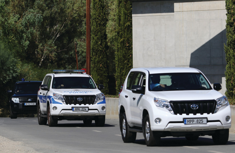  POLICE VEHICLES leave a court, where a remand order was issued against a man suspected of plotting to murder Israeli businesspeople, in Nicosia, 2021. (photo credit: YIANNIS KOURTOGLOU/REUTERS)